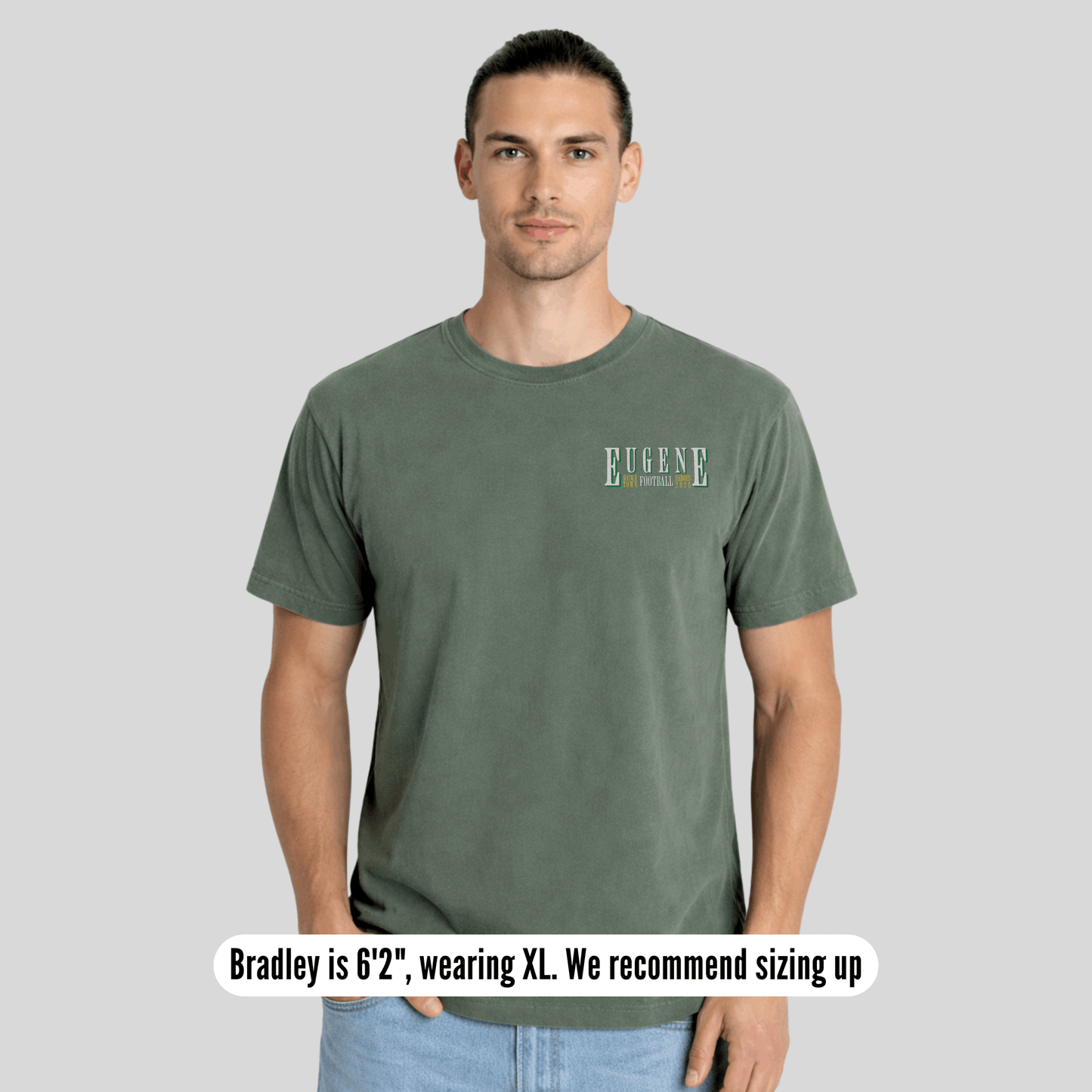Man wearing a green t-shirt with text on a gray background
