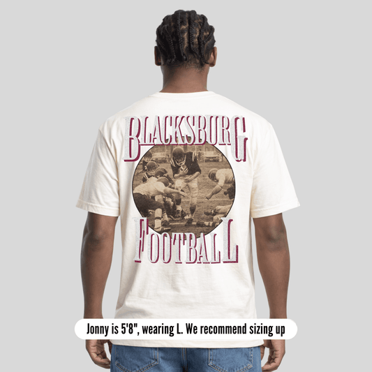 Person wearing a 'Blacksburg Football' t-shirt with a vintage-style graphic on the back.