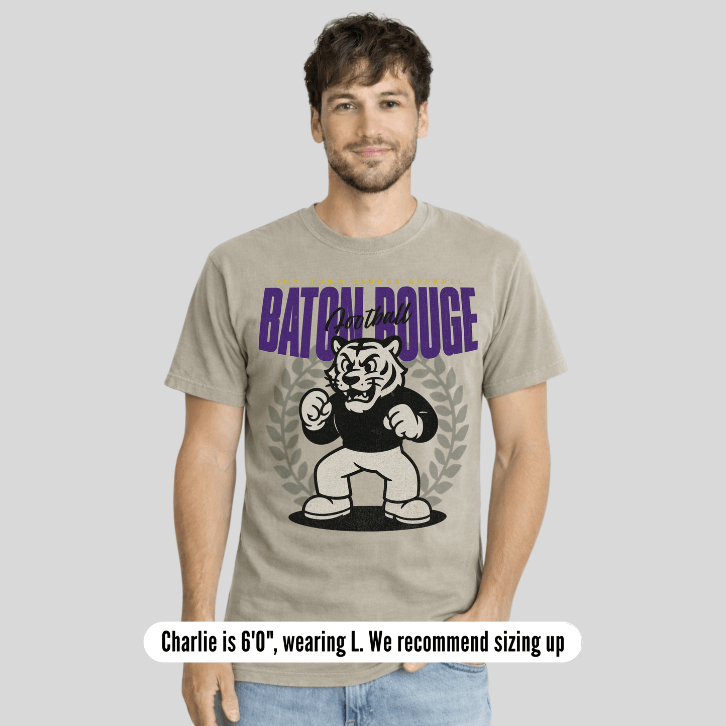 Man wearing a t-shirt with 'Baton Rouge' graphic design on a plain background