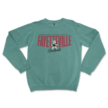 Teal sweatshirt with 'Fayetteville Football' text and logo on a white background
