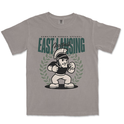 Gray t-shirt with 'East Lansing Football' graphic design on a white background
