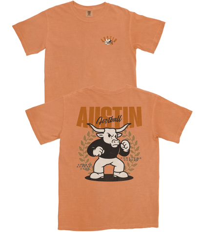 Orange t-shirt with a graphic of a bull and 'Austin Football' text on a white background