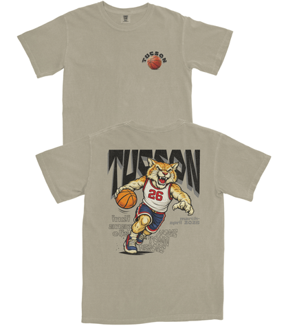 Beige t-shirt with a graphic of a tiger playing basketball and the word 'Tuscan' on a white background.
