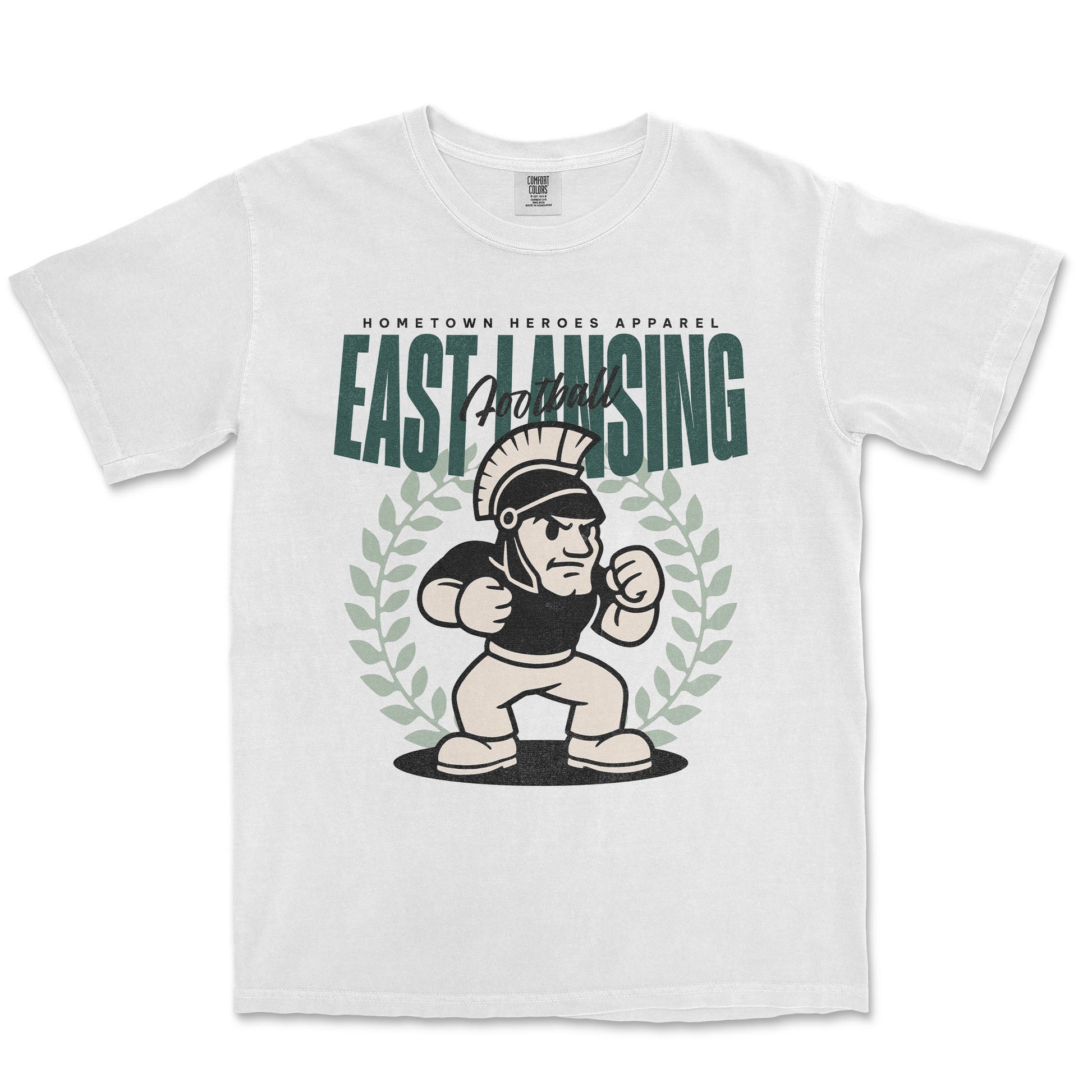 White t-shirt with 'East Lansing' graphic design featuring a cartoon character and laurel wreath on a white background.