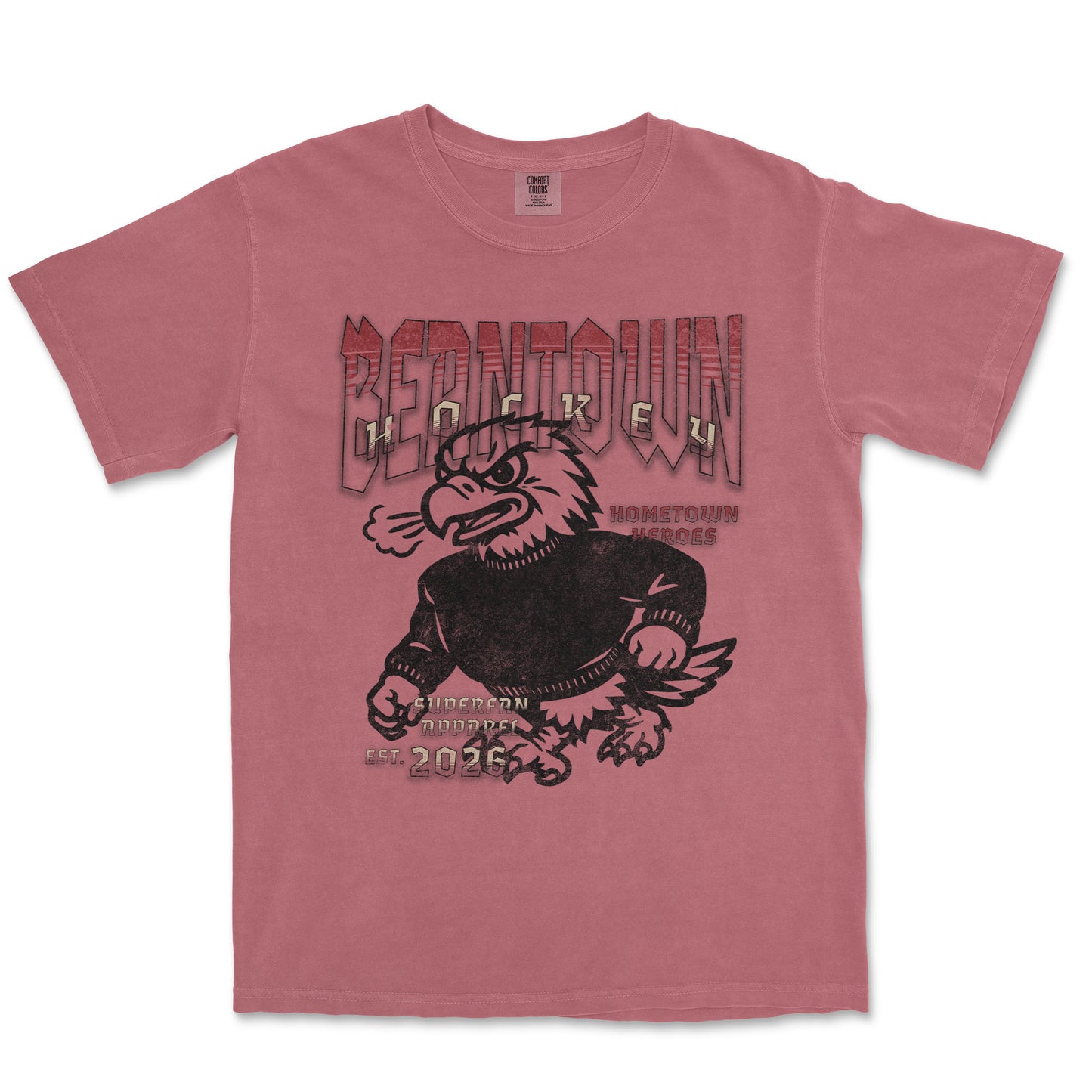 Pink t-shirt with an eagle graphic and text on a white background