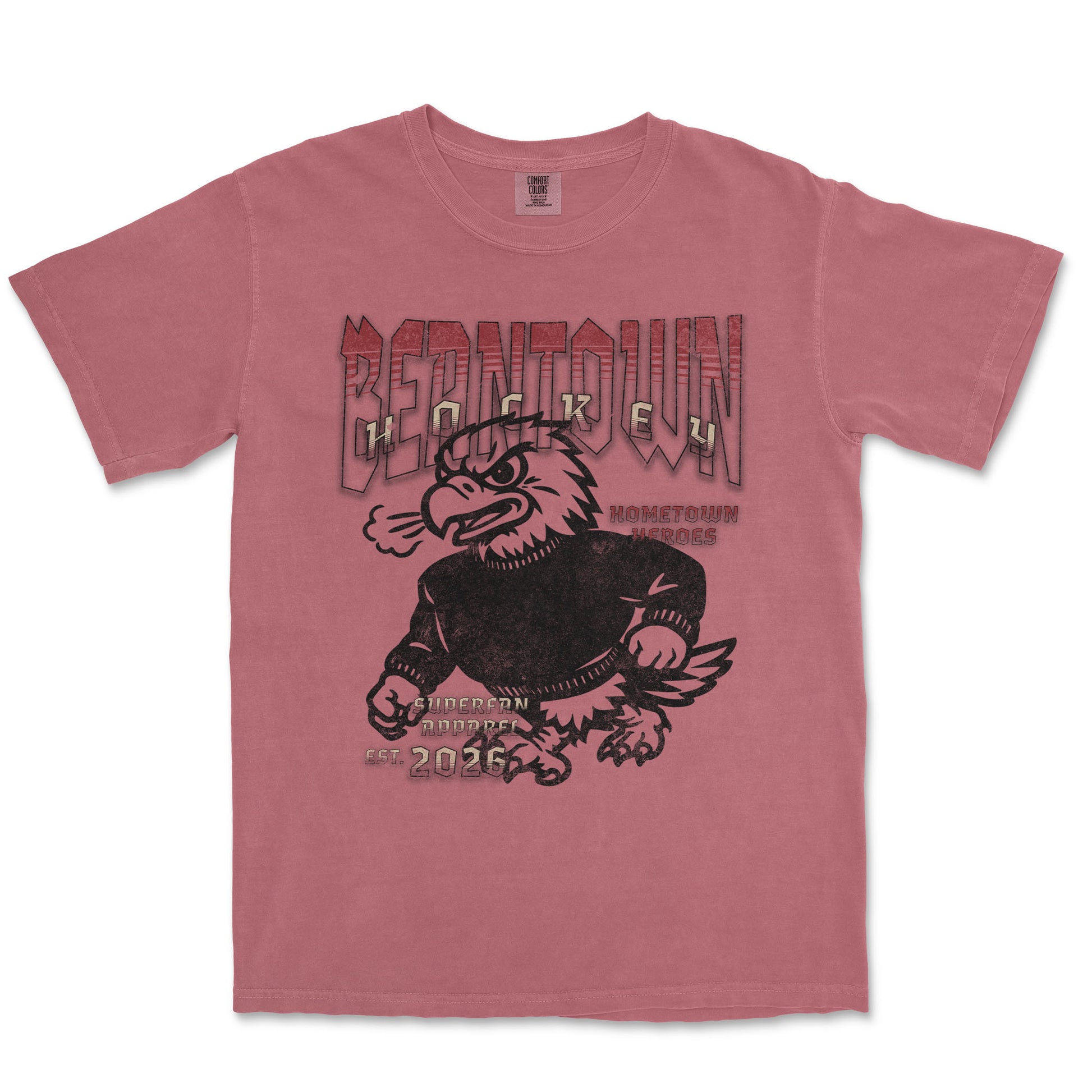 Pink t-shirt with an eagle graphic and text on a white background