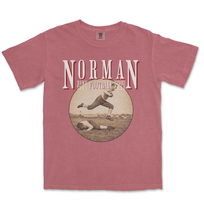 Red t-shirt with vintage football graphic and 'Norman' text on a white background