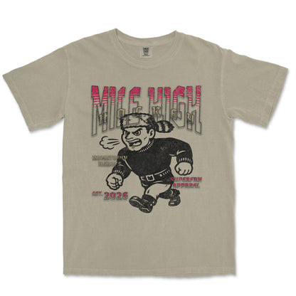 Beige t-shirt with graphic design of a character and text on a white background