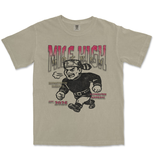 Beige t-shirt with graphic design of a character and text on a white background