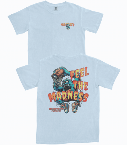 Light blue t-shirt with graphic design and text 'Feel the Madness' on a white background