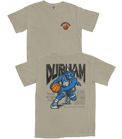 Beige t-shirt with a graphic of a blue creature holding a basketball and the word 'Durham'.