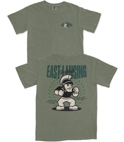 Green t-shirt with 'East Lansing' and cartoon character design on a white background