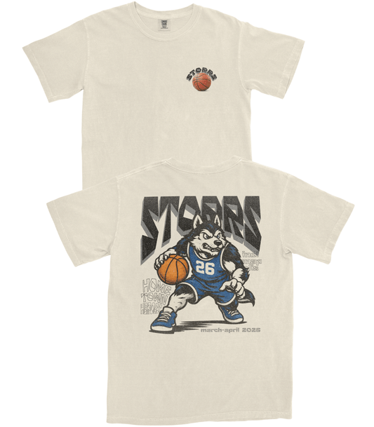 Beige t-shirt with a graphic of a mascot holding a basketball and the word 'STUDS' on a white background.