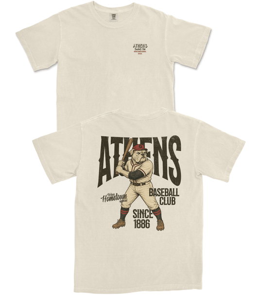 Beige t-shirt with a graphic of a baseball player and text 'Athens Baseball Club' on a white background