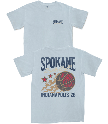 Light blue t-shirt with 'Spokane' and sports-themed graphic on a white background
