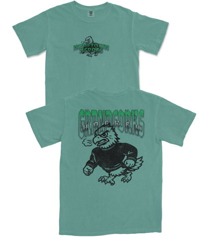 Two teal t-shirts with black graphics and text on a white background