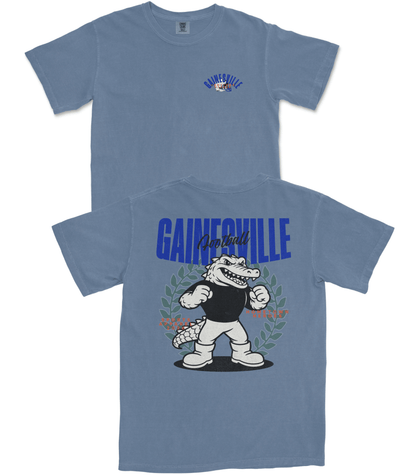 Two blue t-shirts with a cartoon alligator graphic and 'Gainesville' text on a white background.