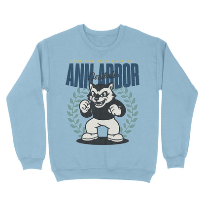 Light blue sweatshirt with a cartoon dog mascot and 'Ann Arbor' text on a white background