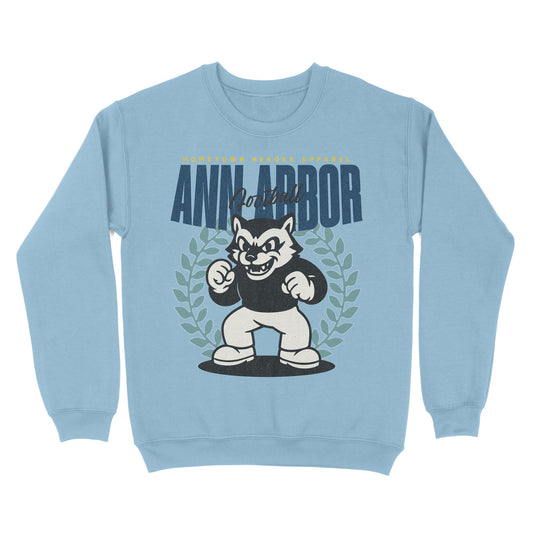 Light blue sweatshirt with a cartoon dog mascot and 'Ann Arbor' text on a white background