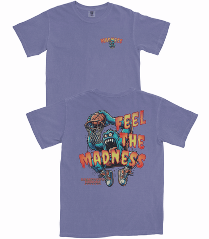 Purple t-shirt with a graphic design of a creature holding a basketball and text 'Feel the Madness' on a white background.