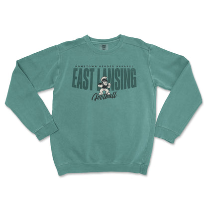 Teal sweatshirt with 'East Lansing Football' text and graphic on a white background