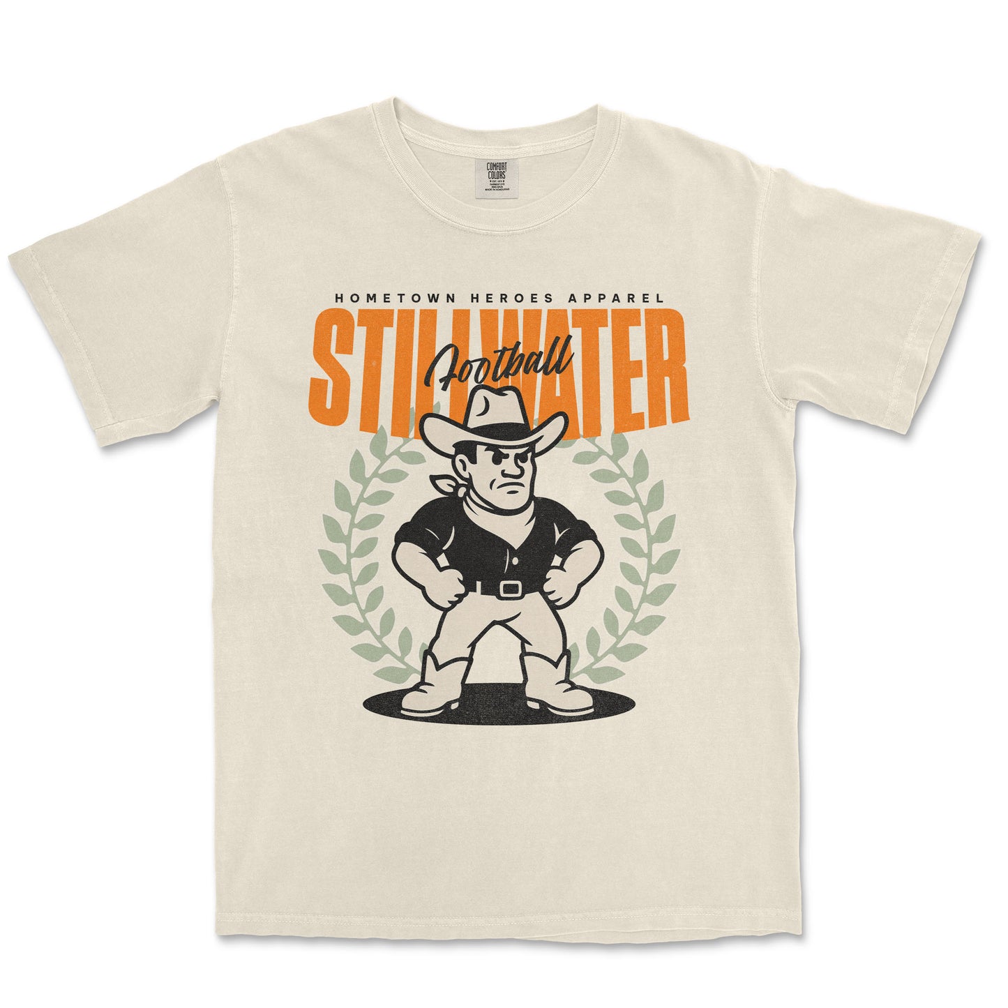 Beige t-shirt with a graphic of a cowboy and text 'Hometown Heroes Apparel Stillwater Football' on a white background
