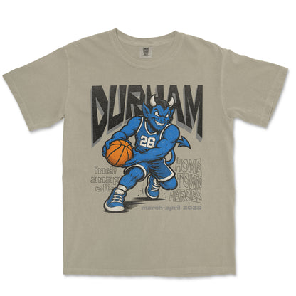 Beige t-shirt with a graphic of a blue mascot holding a basketball and text on a white background
