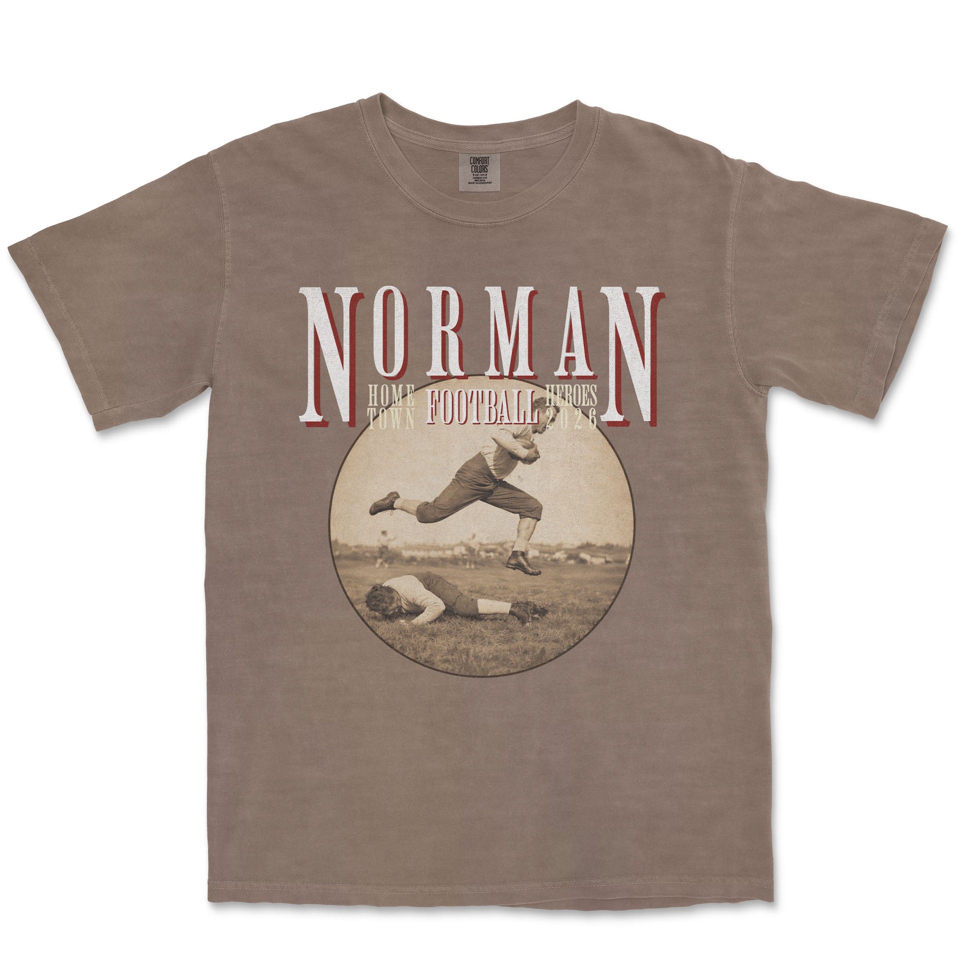 Brown t-shirt with vintage football graphic and 'Norman' text on a white background