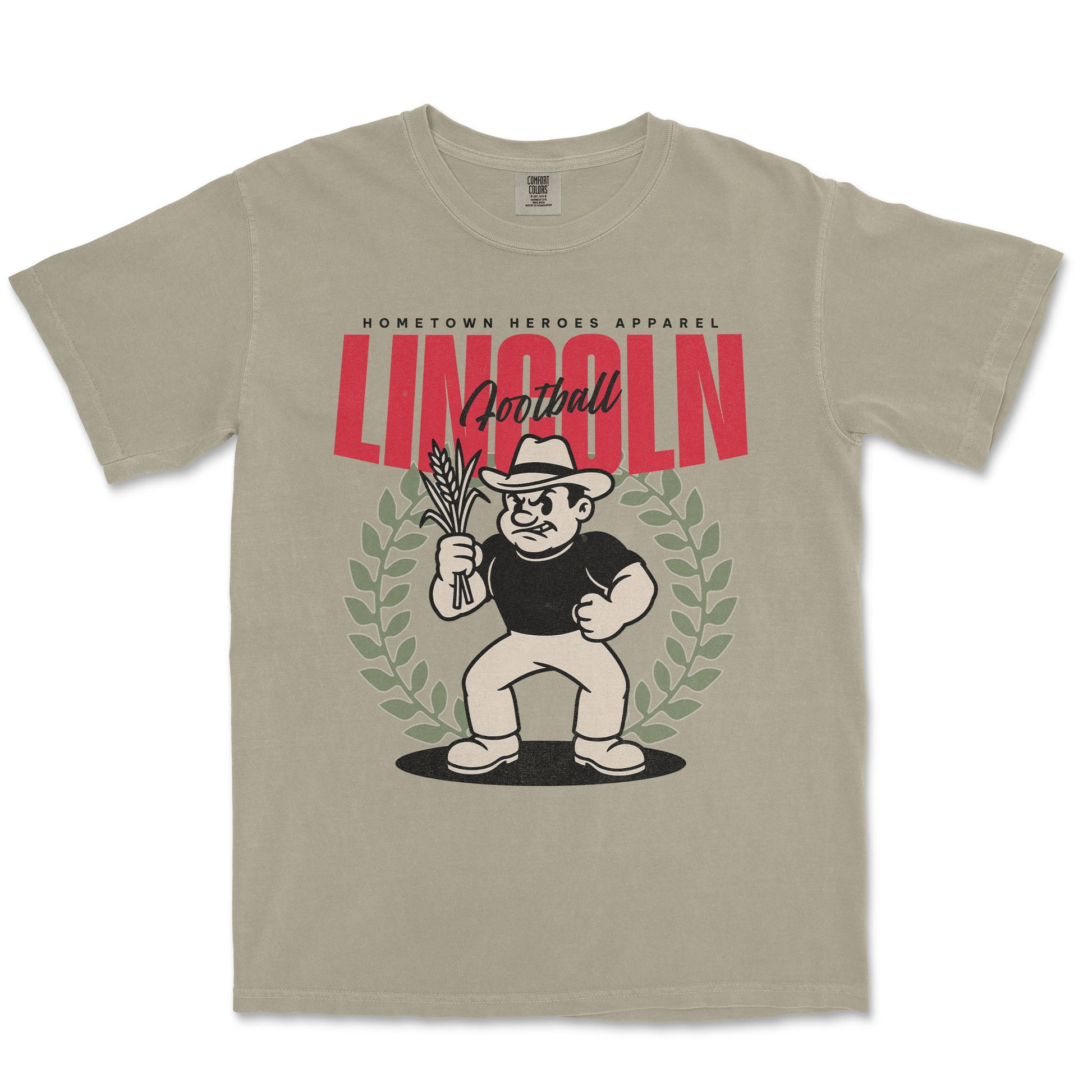 Beige t-shirt with a graphic design featuring a character holding corn and the word 'Lincoln'.