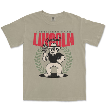 Beige t-shirt with a graphic design featuring a character holding corn and the word 'Lincoln'.