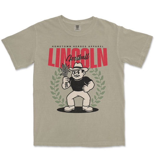 Beige t-shirt with a graphic design featuring a character holding corn and the word 'Lincoln'.