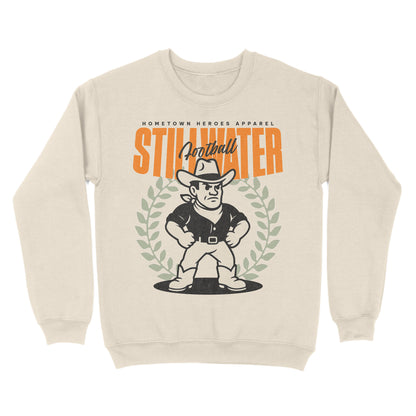 Beige sweatshirt with a graphic of a football player and 'Stillwater' text on a white background
