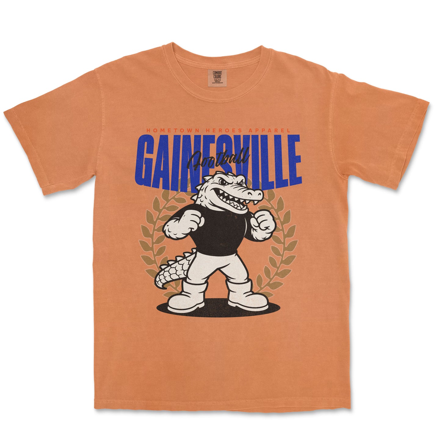 Orange t-shirt with cartoon alligator and 'Gainesville' text on a white background