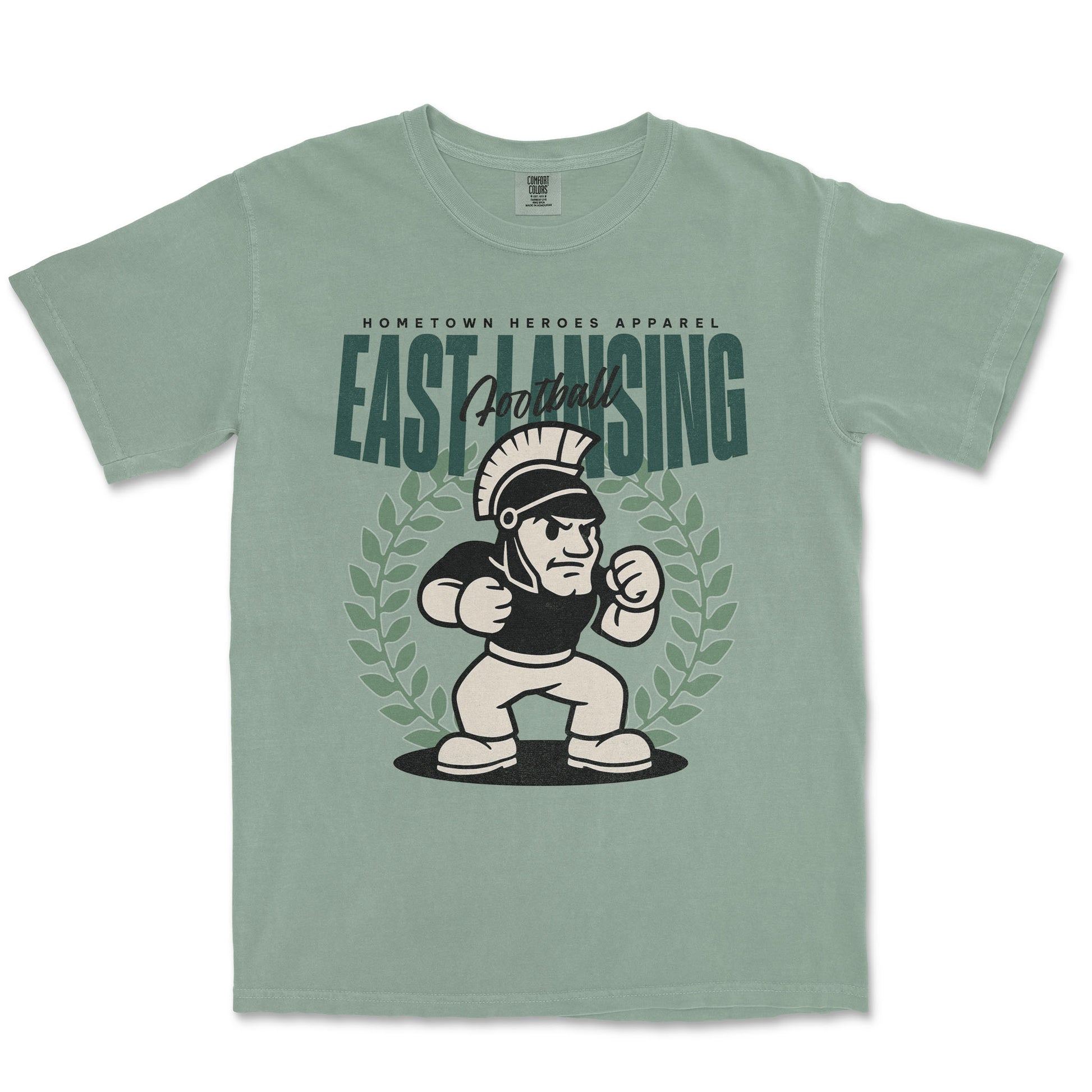 Green t-shirt with cartoon Spartan and 'East Lansing' text on a white background