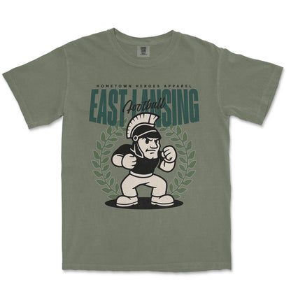Green t-shirt with a graphic of a Spartan and 'East Lansing Football' text on a white background