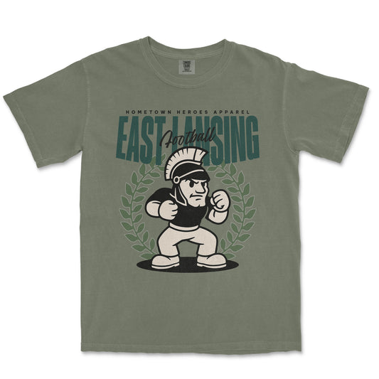 Green t-shirt with a graphic of a Spartan and 'East Lansing Football' text on a white background
