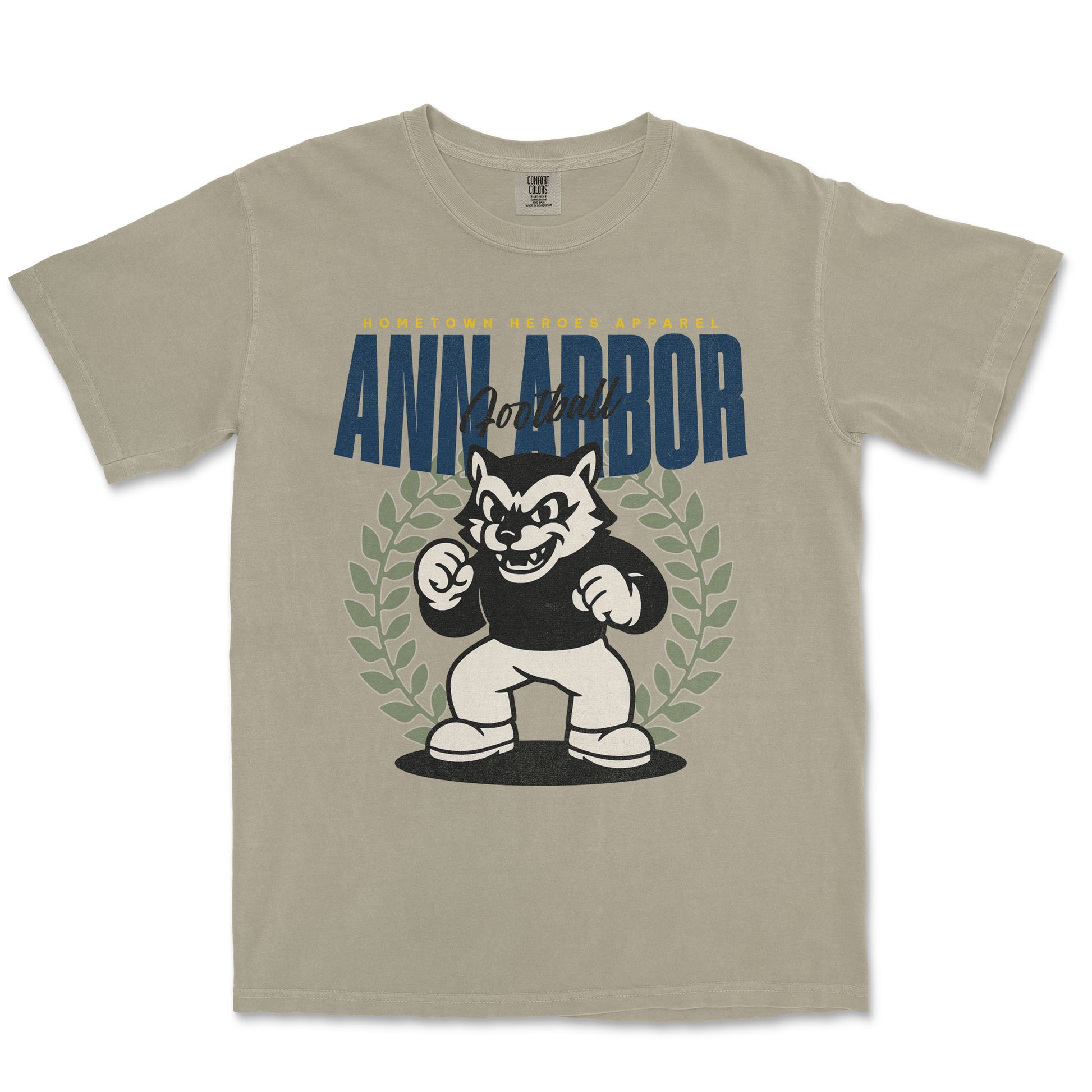 Beige t-shirt with a graphic of a cartoon dog and 'Ann Arbor' text on a white background