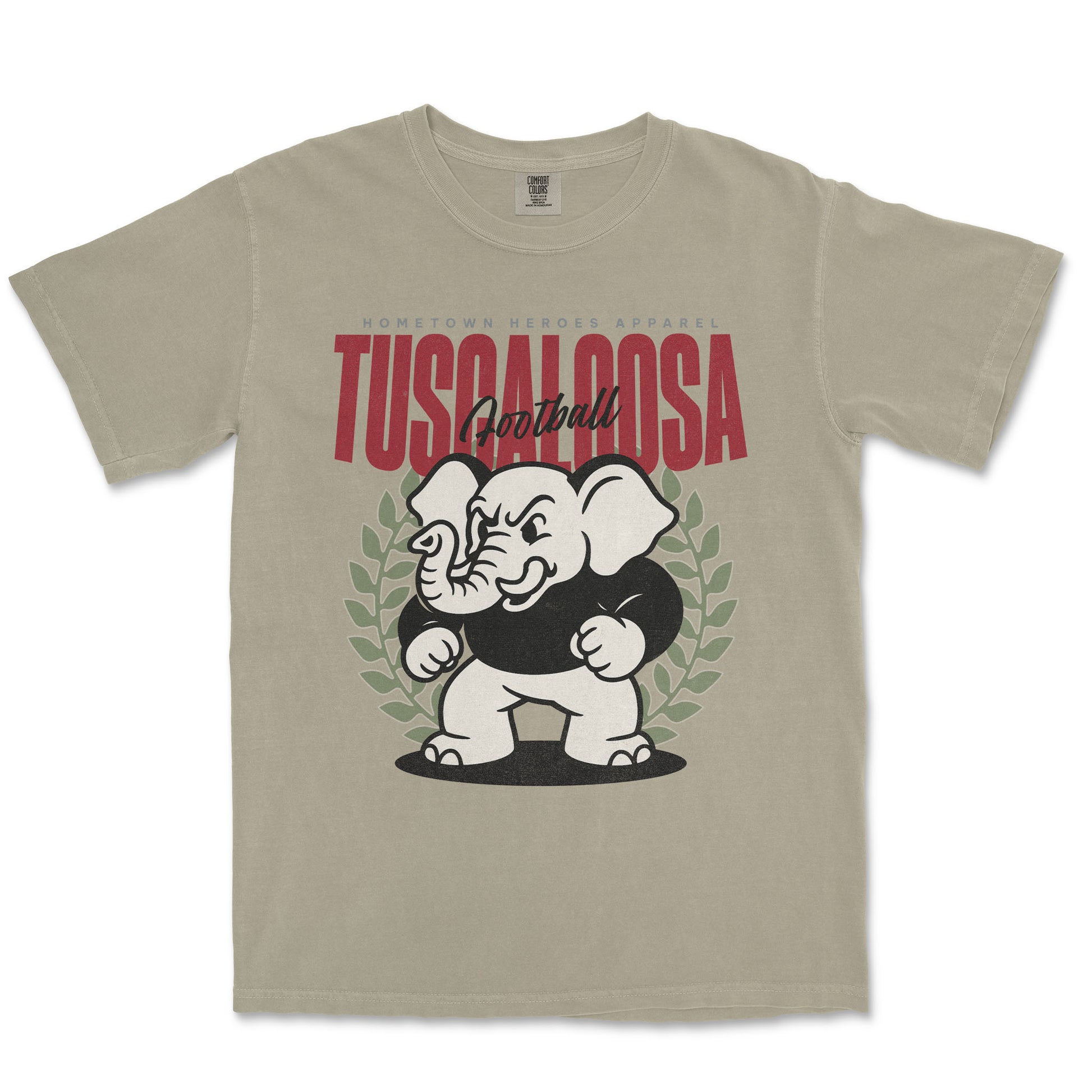 Beige t-shirt with an elephant graphic and 'Tuscaloosa' text on a white background