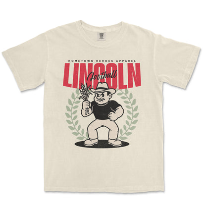 Beige t-shirt with a graphic design featuring a character holding corn and text on a white background