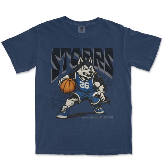 Blue t-shirt with a graphic of a husky holding a basketball and the word 'STORMS' on a white background.