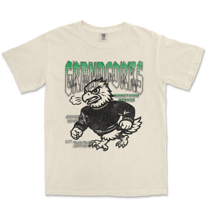 Beige t-shirt with graphic design of a bird-like creature and text on a white background