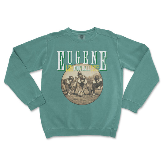 Teal sweatshirt with vintage football graphic and 'Eugene' text on a white background