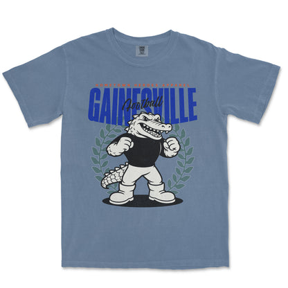 Blue t-shirt with a cartoon alligator and 'Gainesville' text on a white background
