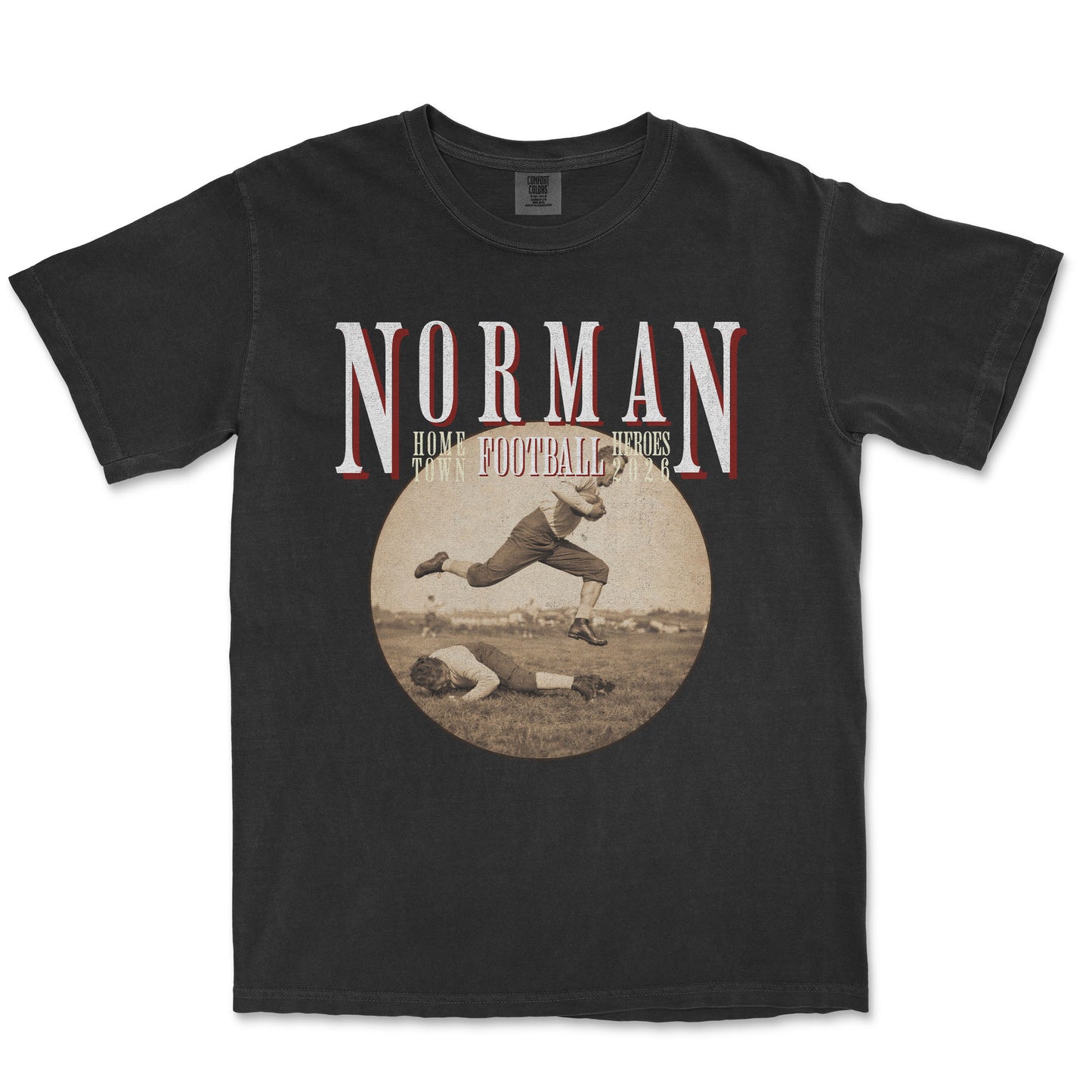 Black t-shirt with vintage football graphic and 'Norman Home Football Heroes' text on a white background
