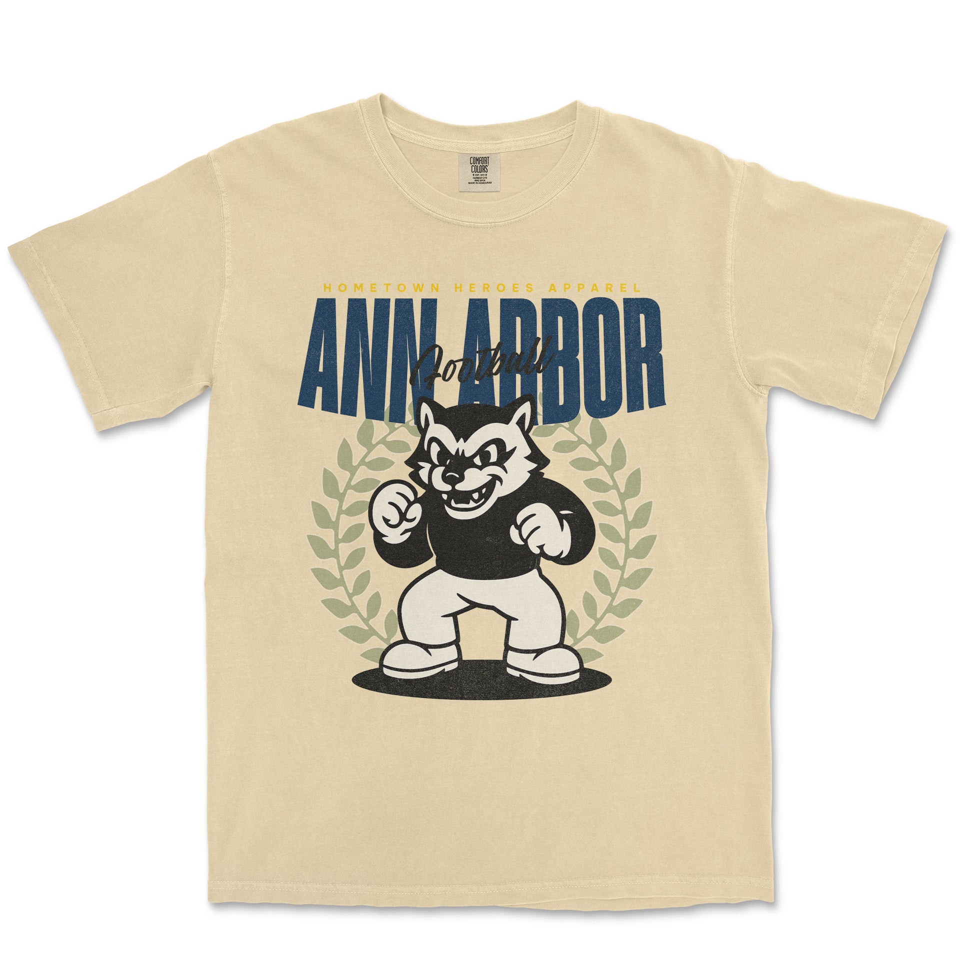 Beige t-shirt with a graphic of a cartoon character and 'Ann Arbor' text on a white background