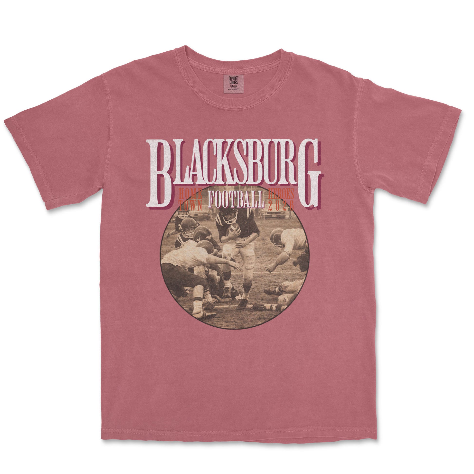 Pink t-shirt with 'Blacksburg Football' graphic on a white background