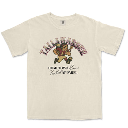 Beige t-shirt with football-themed graphic and text on a white background