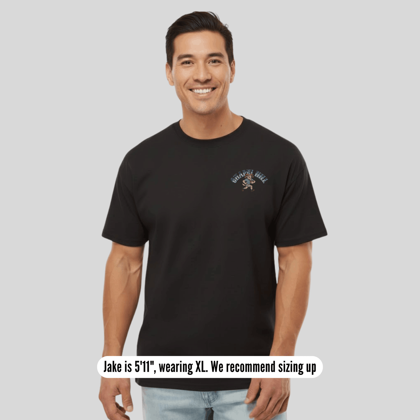 Man wearing a black t-shirt with text on a gray background