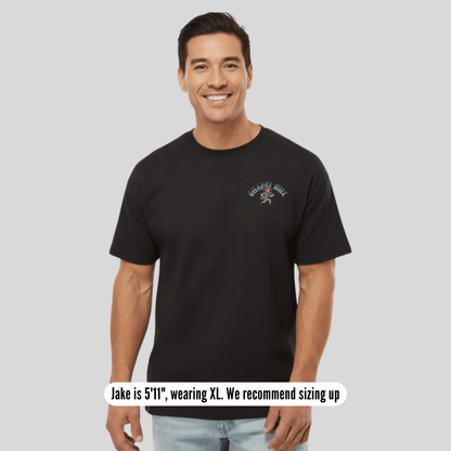 Man wearing a black t-shirt with text on a gray background