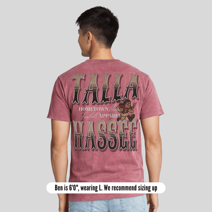 Person wearing a maroon t-shirt with 'Talla Hassee' text and graphics on the back, standing against a plain background.